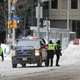 Police patrol the streets near Parliament Hill a day after they cleared a demonstration by truck drivers opposing vaccine mandates that had been entrenched for 23 days on February 20, 2022 in Ottawa, Ontario, Much of the area in downtown Ottawa near Parliament Hill has been declared a secure zone where only residents and people who can prove they have a valid purpose for entering are allowed past checkpoints.